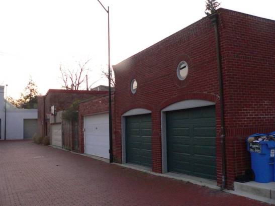 The only accessory buildings that are allowed in this residential district are private garages and artists studios, so you are starting to see some fancier garages that are built up to the maximum height of 15’, which effectively prohibits a second story:. 