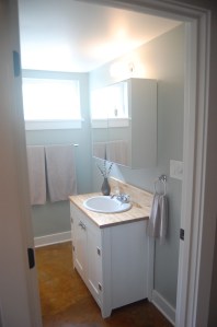 the bathroom sink is salvaged and the vanity made from cabinet-grade plywood scraps
