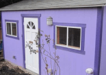 photo of a very small purple shed for rent as a dwelling