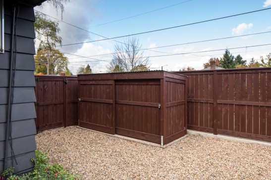 the bike storage shed for this Hammer & Hand ADU blends right in with the fence