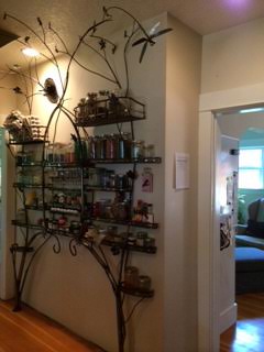 The spice rack (also created by Gustav Artist) provides plenty of space for spices in the shared kitchen of Lisa's rooming house.